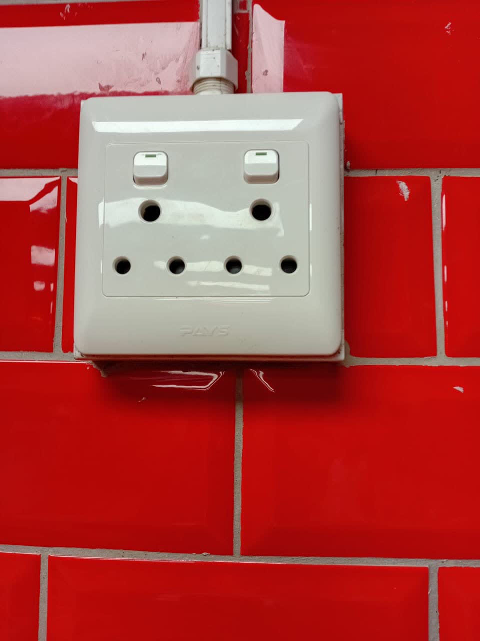 New double wall plug socket surface-mounted on tiled wall by Happ's Electrical