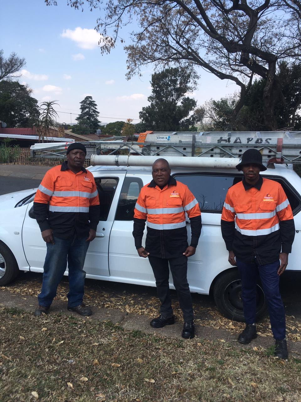 Happ's Electrical technicians in high-visibility uniforms in front of the company vehicle