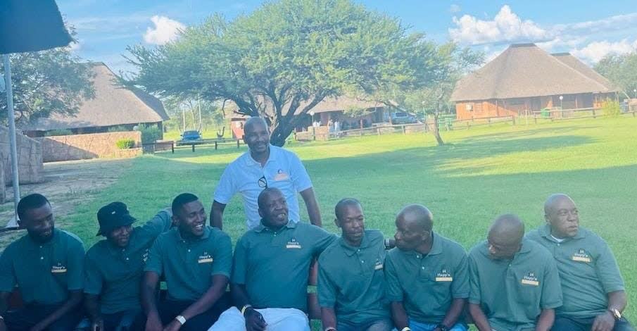 The full Happ's Electrical & Maintenance team in branded green shirts at a company gathering in South Africa