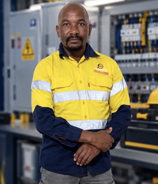 Happy Mogotla, founder and owner of Happ's Electrical & Maintenance, in branded high-visibility workwear
