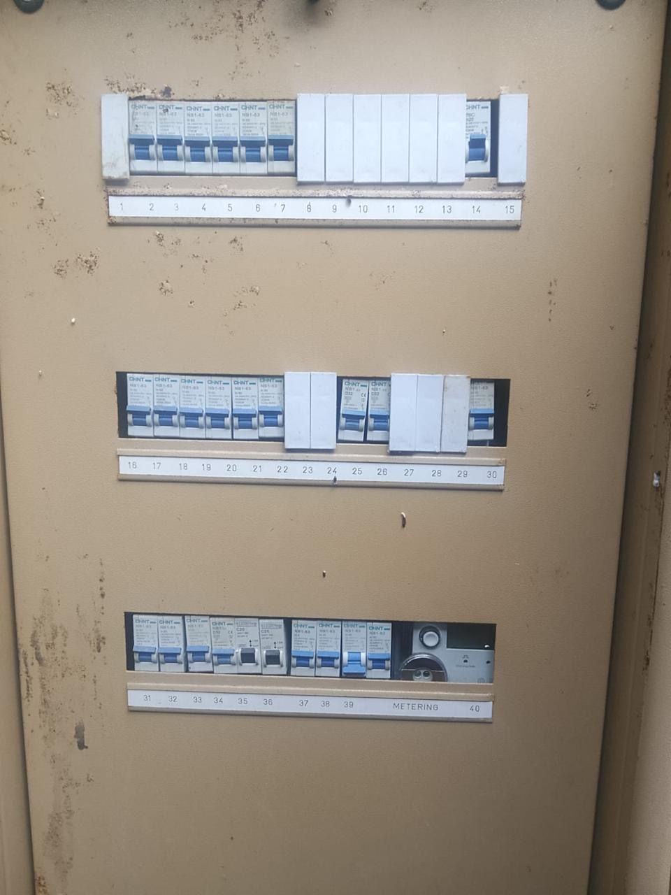 Numbered and labelled circuit breakers in a commercial distribution board serviced by Happ's Electrical